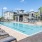 a pool with lounge chairs around it