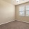 a room with a ceiling fan and a carpet