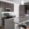 a kitchen with a bar stool and a refrigerator